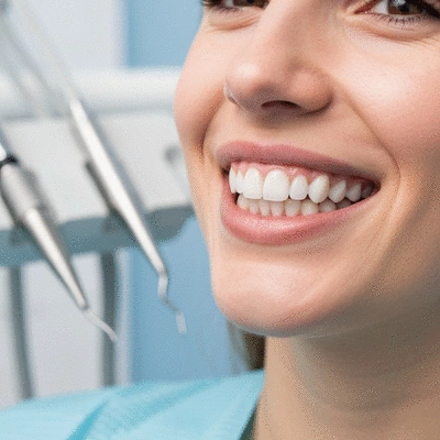Close-up of a patient with a perfectly designed smile, showing healthy white teeth, in a bright, professional setting, no text, no words, no typography, clean image