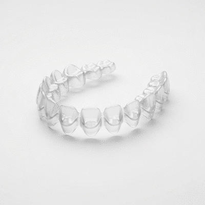 Close-up of clear Invisalign aligners on a white background