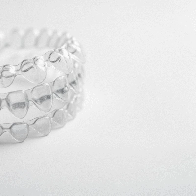Close-up of clear Invisalign aligners on a white background
